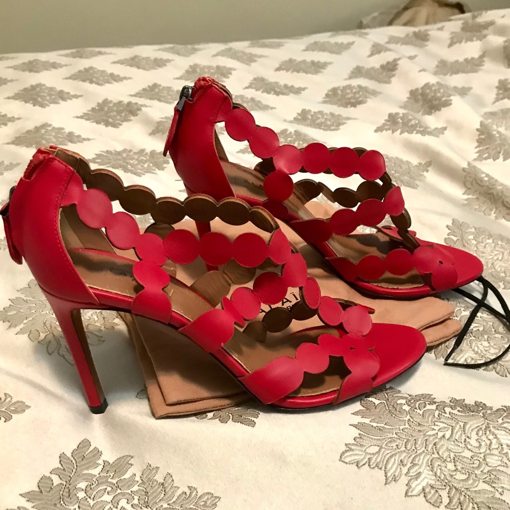 Red strappy Alaia stilettos